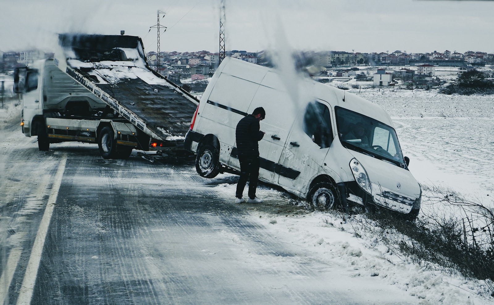 a man standing next to a white van on the side of a road